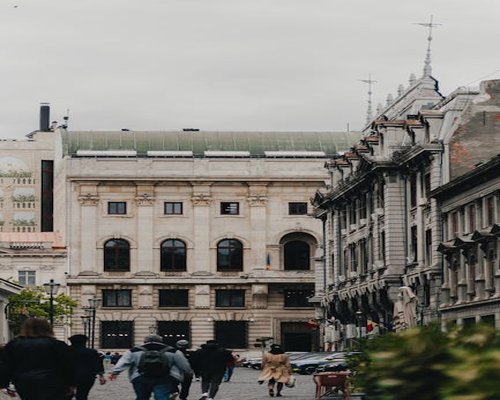 Atmospheric scene of contemporary pedestrian routine in a central district of Bucharest with active morning sunlight hitting classic facades