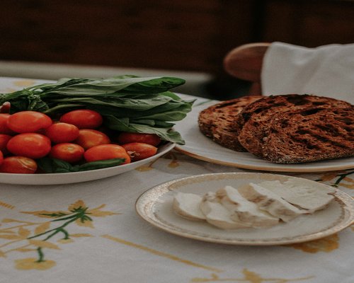 A morning breakfast preparation showcasing dynamic styling with sourdough slices cottage cheese and ripe cherry tomatoes